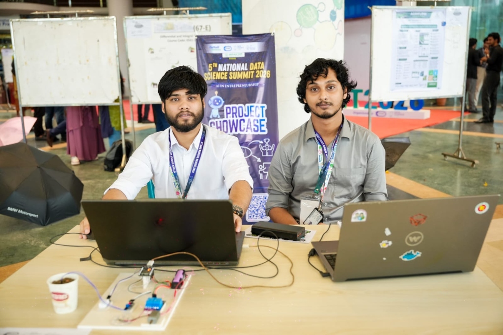 Teammates sitting at the team presentation desk with laptops at the 5th National Data Science Summit 2026